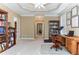 Spacious home office featuring a large window, built-in bookshelves, and a ceiling fan at 3240 Somerset Se Ct, Conyers, GA 30013