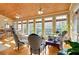 Bright sunroom boasting a wood ceiling, lots of windows, and views of the surrounding landscape at 3240 Somerset Se Ct, Conyers, GA 30013