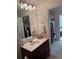 Bathroom featuring a vanity with dark wood cabinets, a large mirror, and a glimpse into the closet at 230 E Ponce De Leon Ave # 210, Decatur, GA 30030