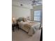 A bright bedroom featuring neutral walls, ceiling fan, and a comfortable bed with decorative pillows at 230 E Ponce De Leon Ave # 210, Decatur, GA 30030