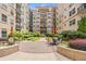 Beautiful courtyard featuring landscaped grounds, seating, and multi-story residential buildings at 230 E Ponce De Leon Ave # 210, Decatur, GA 30030