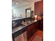 Modern kitchen with dark countertops, stainless steel sink, and dark wood cabinets at 230 E Ponce De Leon Ave # 210, Decatur, GA 30030
