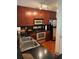 Beautiful kitchen with stainless steel appliances, wood cabinets, and a breakfast bar setup at 230 E Ponce De Leon Ave # 210, Decatur, GA 30030
