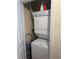A compact stacked washer and dryer unit maximizing space in a closet with organizing equipment at 230 E Ponce De Leon Ave # 210, Decatur, GA 30030