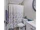 Clean bathroom with shower/tub combo and floral shower curtain at 3004 Hidden Lake Dr, Duluth, GA 30096