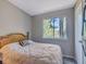 Bright bedroom with a wooden bed frame and window overlooking trees at 3004 Hidden Lake Dr, Duluth, GA 30096