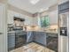 Modern kitchen with stainless steel appliances and blue gray cabinets at 3004 Hidden Lake Dr, Duluth, GA 30096