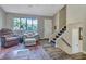 Bright living room with hardwood floors, comfortable seating, and access to stairs at 3004 Hidden Lake Dr, Duluth, GA 30096