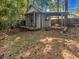 Grey storage shed with a covered area in the backyard at 3004 Hidden Lake Dr, Duluth, GA 30096