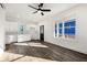 Open living room and kitchen area with hardwood floors and white cabinets at 1088 Wedgewood Nw Dr, Atlanta, GA 30318