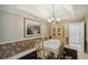 Formal dining room, featuring a beautiful chandelier and hardwood floors at 710 Stonehenge Pl, Jonesboro, GA 30236