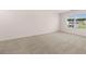 Large bedroom with neutral carpeting and a window at 4107 Spencer Trl, Stonecrest, GA 30038