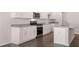 Modern kitchen with white cabinets, granite counters and island at 4107 Spencer Trl, Stonecrest, GA 30038