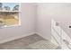 Laundry room with tile floor, window, and built-in shelving at 4107 Spencer Trl, Stonecrest, GA 30038