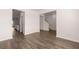 Spacious living room with hardwood floors and views to kitchen and stairs at 4107 Spencer Trl, Stonecrest, GA 30038