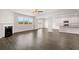 Open living room features fireplace, hardwood floors, and access to kitchen at 4107 Spencer Trl, Stonecrest, GA 30038