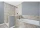 Spacious bathroom featuring decorative tile walls and a shower and tub at 1159 Fair Sw St, Atlanta, GA 30314