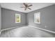 Cozy bedroom with neutral paint, ceiling fan, and gray plank floors at 1159 Fair Sw St, Atlanta, GA 30314