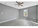 Bedroom with neutral paint, ceiling fan and gray plank floors at 1159 Fair Sw St, Atlanta, GA 30314