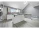 Bright kitchen features white cabinets, center island, and modern gray color palette at 1159 Fair Sw St, Atlanta, GA 30314