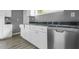 Kitchen with white cabinets, gray countertop, and stainless steel appliances at 1159 Fair Sw St, Atlanta, GA 30314