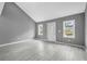 Bright living room with neutral paint, recessed lighting, and gray plank floors at 1159 Fair Sw St, Atlanta, GA 30314