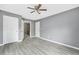 Main bedroom featuring plank floors and doors to closets and en-suite bathroom at 1159 Fair Sw St, Atlanta, GA 30314