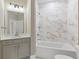Well-lit bathroom featuring a vanity with drawers, bathtub, and modern tile work at 5225 Ginger Rose Ct, Cumming, GA 30028