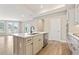 Stylish kitchen island with white marble countertops, stainless steel appliances, and custom cabinets at 5225 Ginger Rose Ct, Cumming, GA 30028