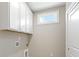 Bright laundry room featuring white cabinets for ample storage and a practical design at 5225 Ginger Rose Ct, Cumming, GA 30028
