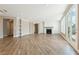 Open floor plan featuring beautiful wood floors, fireplace, and a wall of windows at 5225 Ginger Rose Ct, Cumming, GA 30028