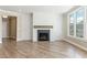 Bright living room features a modern fireplace and large windows with backyard views at 5225 Ginger Rose Ct, Cumming, GA 30028