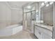 Bathroom features tub, glass shower, granite countertop, and tile flooring at 2867 Darlington Run, Duluth, GA 30097