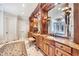 Elegant bathroom with ornate wood cabinetry, marble countertops, and luxurious fixtures at 2867 Darlington Run, Duluth, GA 30097