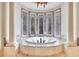 Bathroom featuring a marble jacuzzi tub with decorative windows at 2867 Darlington Run, Duluth, GA 30097