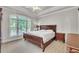 Bedroom with tray ceiling, large window, and traditional furnishings at 2867 Darlington Run, Duluth, GA 30097