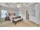 Bedroom with coffered ceiling, built in bookcase, and doorway to walk in closet at 2867 Darlington Run, Duluth, GA 30097