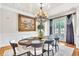 Elegant dining room featuring a chandelier, wainscoting, and access to an outdoor balcony at 2867 Darlington Run, Duluth, GA 30097