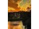 Beautiful exterior view of a brick house at sunset reflected in a serene lake at 2867 Darlington Run, Duluth, GA 30097