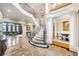 Grand foyer showcasing a curved staircase, marble floors, and elegant living and dining spaces at 2867 Darlington Run, Duluth, GA 30097