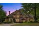 Elegant brick home with a paved driveway, manicured lawn, and mature landscaping at 2867 Darlington Run, Duluth, GA 30097