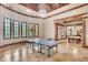 Bright game room with a ping pong table, wood trim and doorway to the pool room at 2867 Darlington Run, Duluth, GA 30097