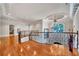 Upstairs hallway with hardwood floors, chandelier, and elegant iron railing, showcasing an open layout at 2867 Darlington Run, Duluth, GA 30097