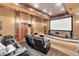 Home theater with tiered seating, projector screen, and high-end sound system at 2867 Darlington Run, Duluth, GA 30097
