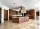 Gourmet kitchen features a large island, custom cabinets, and tile floors at 2867 Darlington Run, Duluth, GA 30097