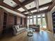 Beautiful living room featuring custom built-ins, hardwood floors, and a coffered ceiling at 2867 Darlington Run, Duluth, GA 30097
