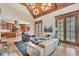 Open-concept living room with a kitchen view, featuring hardwood floors and large windows at 2867 Darlington Run, Duluth, GA 30097