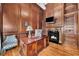 Wood-paneled office with fireplace, desk, and shelving, offering a sophisticated workspace at 2867 Darlington Run, Duluth, GA 30097