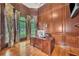 Wood-paneled office featuring a large desk, hardwood floors, and natural light from the windows at 2867 Darlington Run, Duluth, GA 30097