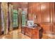 Wood-paneled office featuring a large desk, hardwood floors, and natural light from the windows at 2867 Darlington Run, Duluth, GA 30097